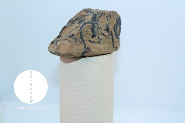 wavy sand dropper box with a rock on top to illustrate the box sturdy integrity and support
