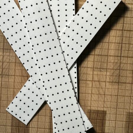 Polka dot envelope on a wooden cutting board