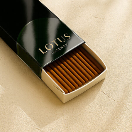 3-quarter view of a DIY 2-Tone Black Glossy Sleeve + White Tray Incense Packaging by UX BOXES® with the Prominent™ Box LabelsSeries that reads: LOTUS INCENSE. The box lays on a off-white sandstone countertop.