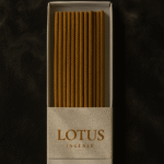 Top view of a DIY Incense White Packaging by UX BOXES® with a Colossal™ Box Band that reads: LOTUS INCENSE. The box lays flat on a black sandstone countertop