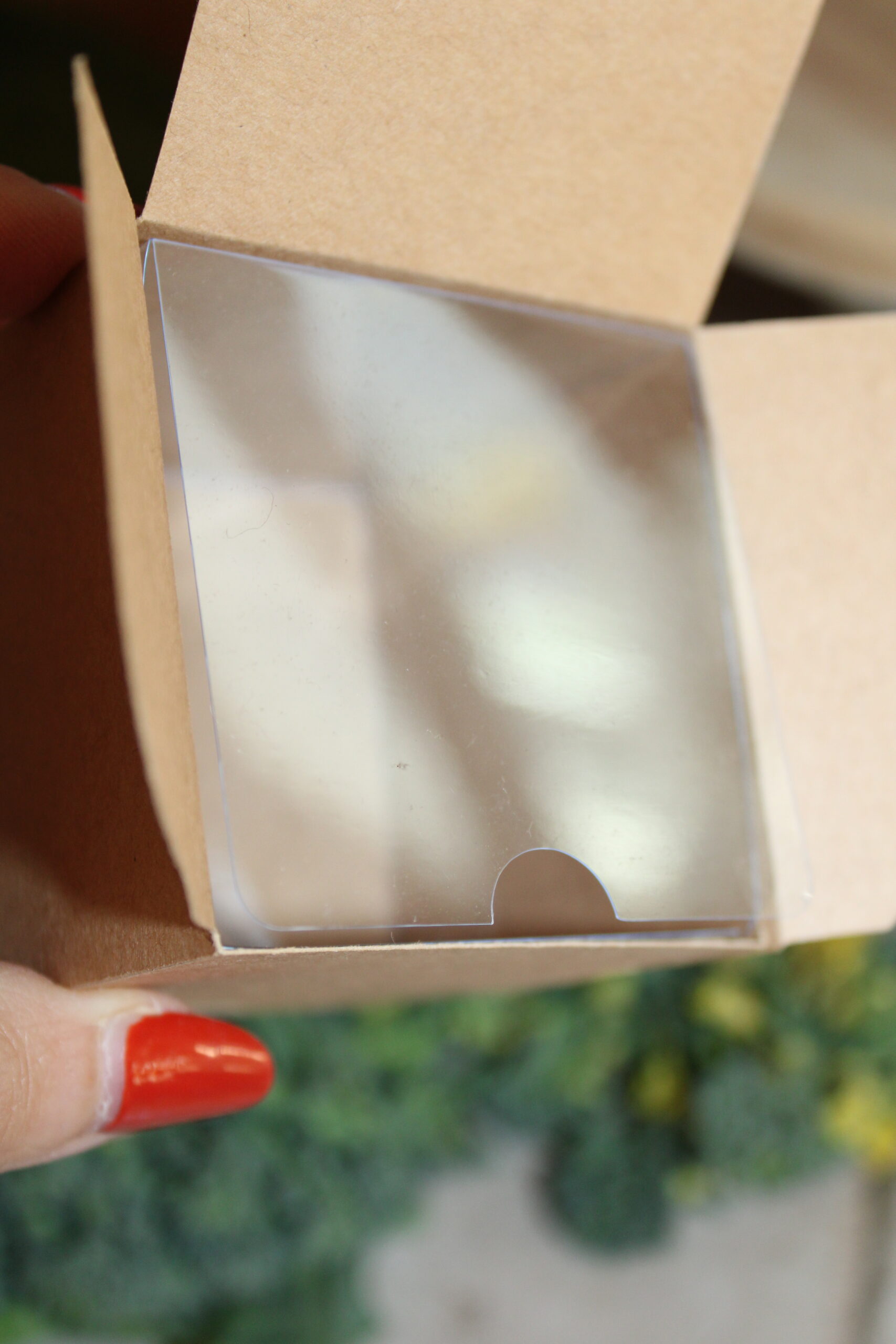 Kraft Cream Jar Square Box with a clear plastic insert sitting open on bed of broccoli