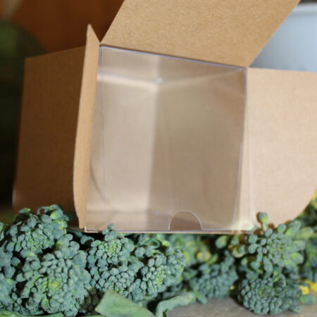 Kraft Cream Jar Square Box with a clear plastic insert sitting open on bed of broccoli