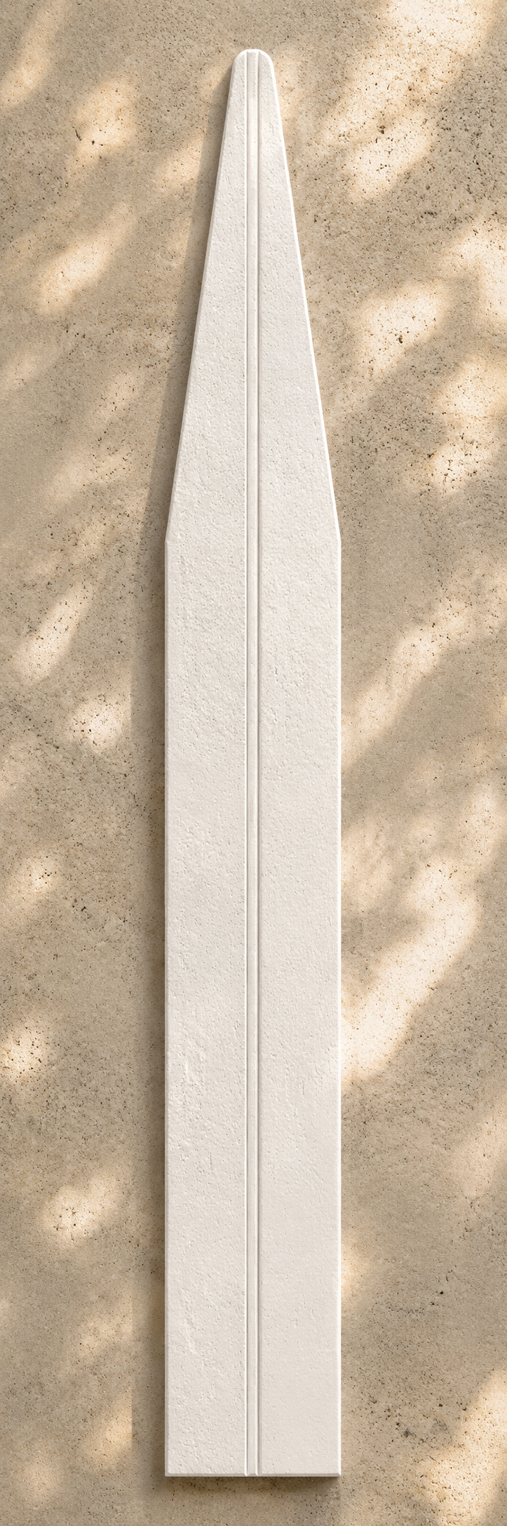White tapered scent strip with a central groove and porous matte texture on a creamy sandstone surface with soft sun-dappled shadows.